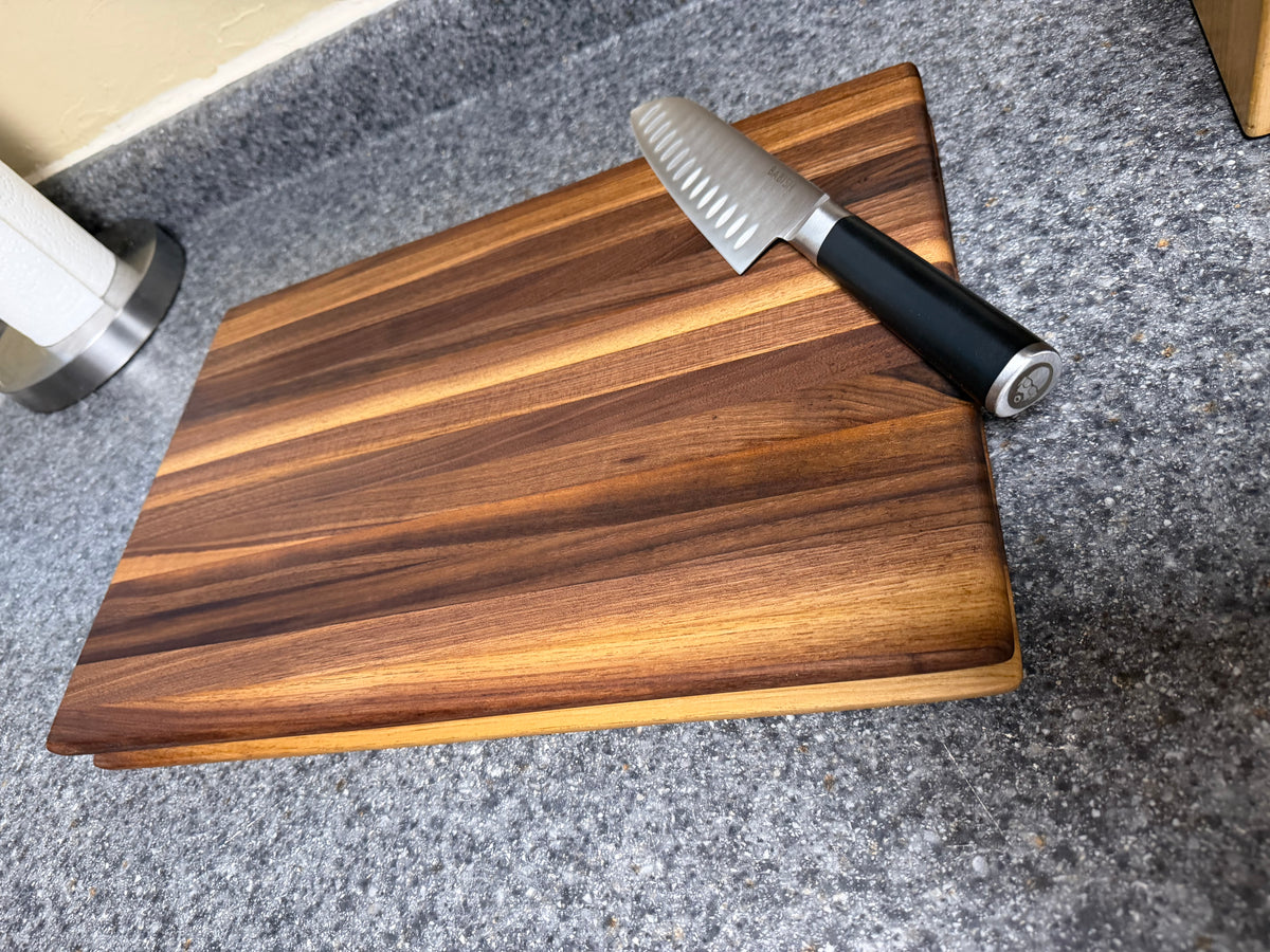 17-1/2"X11-1/2"X1-1/2" Walnut Edge Grain Cutting Board w/Unique Hand Hold around the sides.