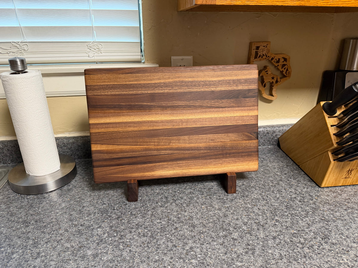 17-1/2"X11-1/2"X1-1/2" Walnut Edge Grain Cutting Board w/Unique Hand Hold around the sides.