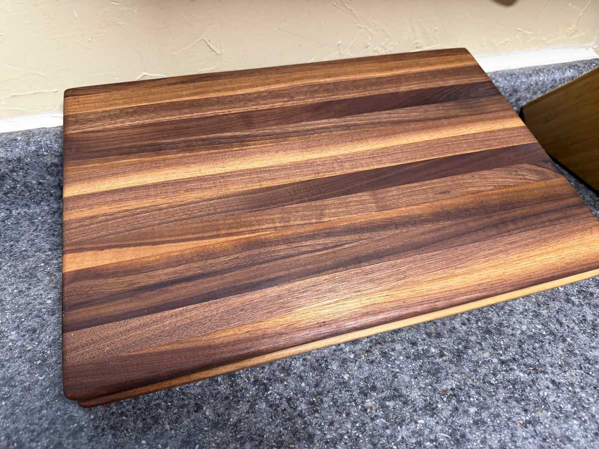 17-1/2"X11-1/2"X1-1/2" Walnut Edge Grain Cutting Board w/Unique Hand Hold around the sides.