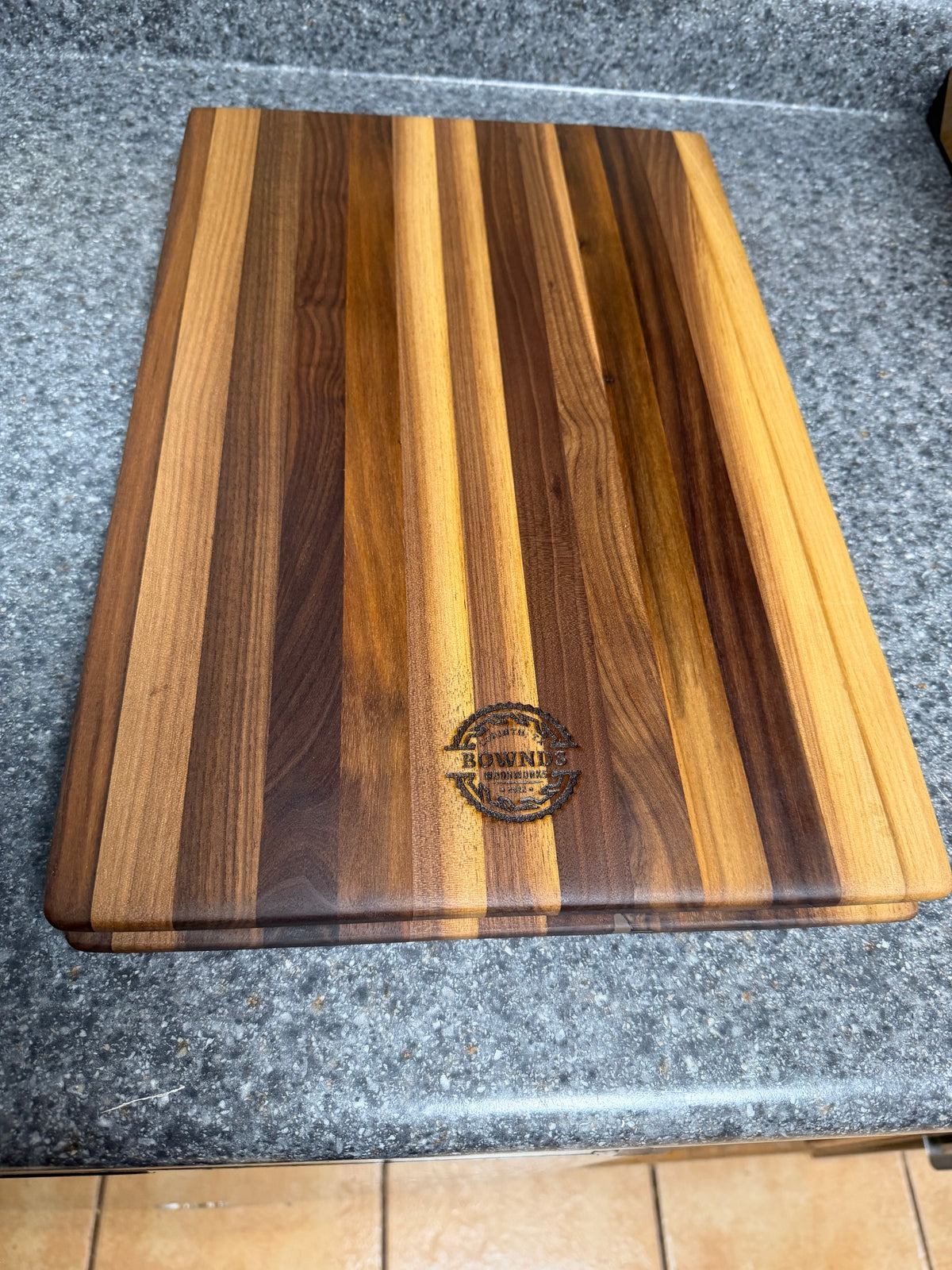 17-1/2"X11-1/2"X1-1/2" Walnut Edge Grain Cutting Board w/Unique Hand Hold around the sides.
