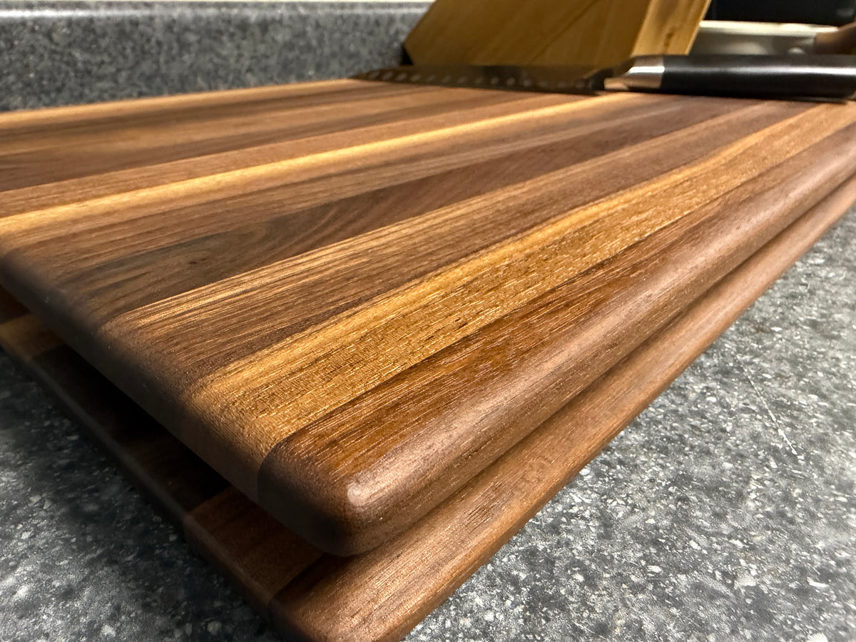 17-1/2"X11-1/2"X1-1/2" Walnut Edge Grain Cutting Board w/Unique Hand Hold around the sides.