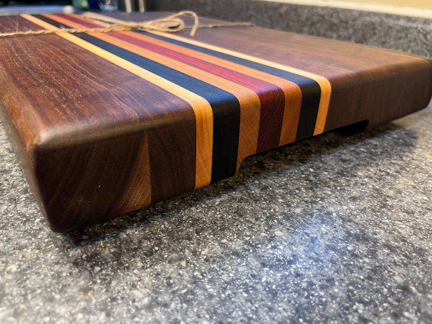 19-5/8"L X 13"W X 2"H Walnut edge grain cutting board with cherry, maple, African wenge & padauk accent strips.