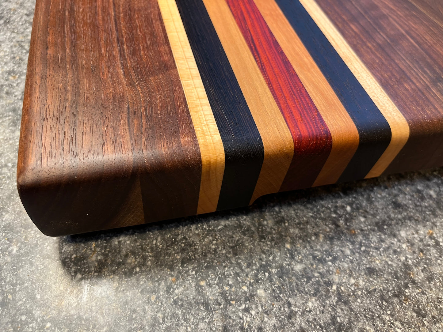 19-5/8"L X 13"W X 2"H Walnut edge grain cutting board with cherry, maple, African wenge & padauk accent strips.