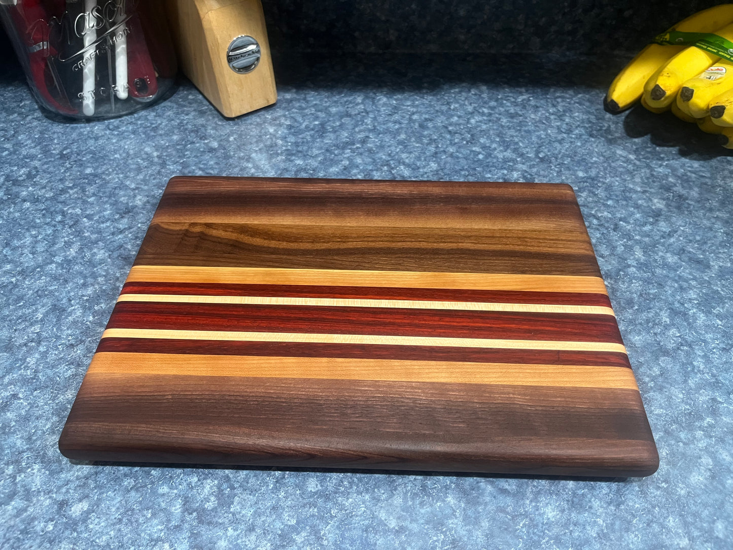 13-7/8"L X 10"W X 1"H Edge Grain Walnut Cutting Board with Cherry, Maple, Padauk accent strips