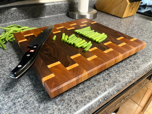 13-3/8" X 12-3/8" X 1-1/2 "End Grain Cutting Board-Walnut and Cherry with Maple accent strips with beveled edges and rubber feet attached