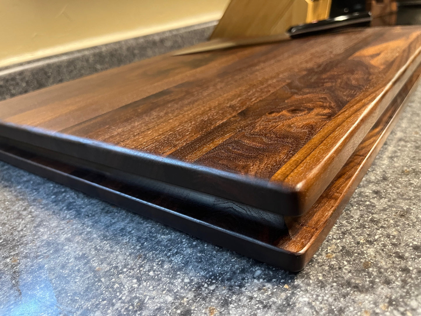 20"X16-1/4"X2" Walnut Edge Grain Cutting Board with unique hand all the way around the edges. No rubber feet.