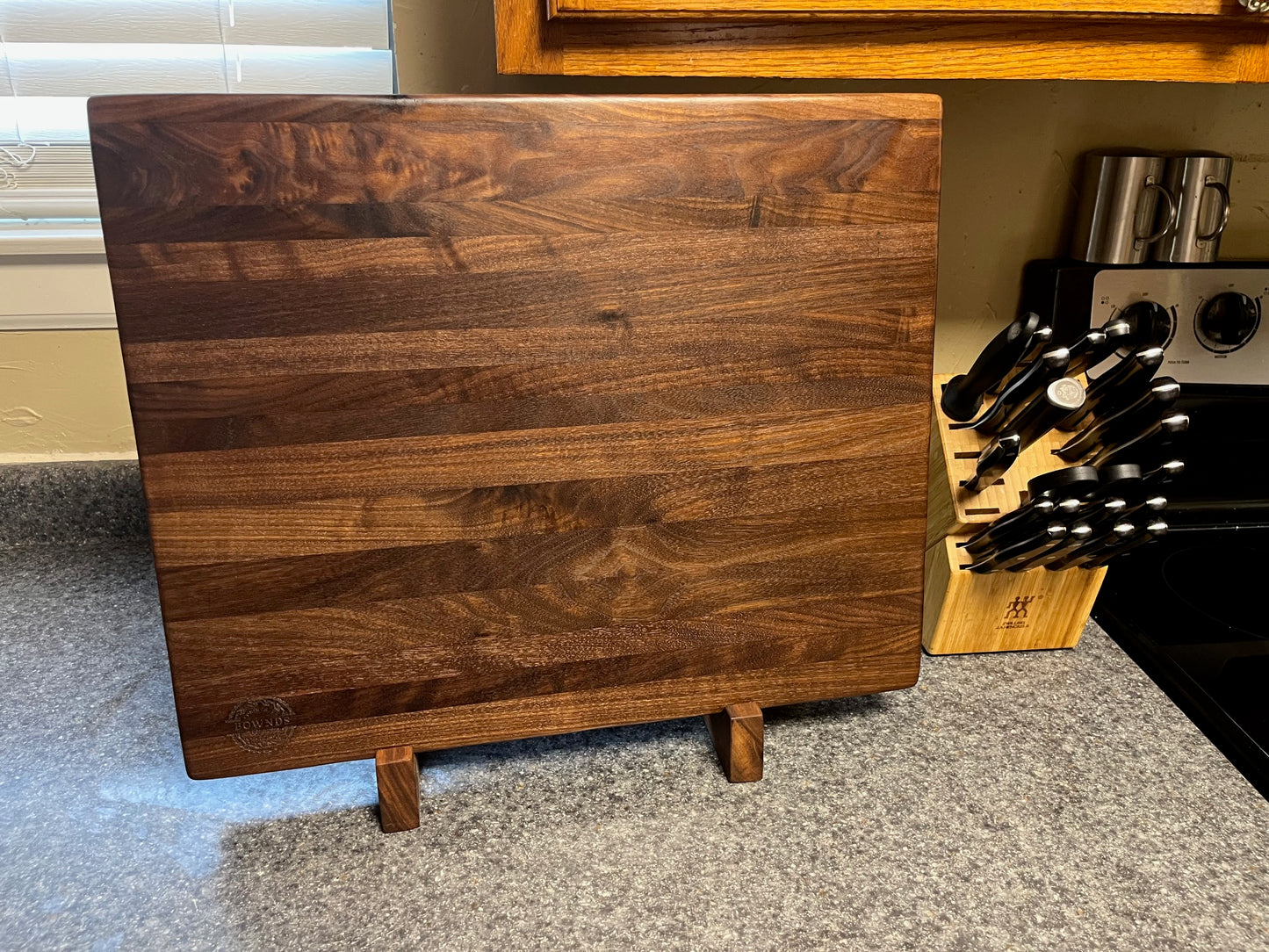 20"X16-1/4"X2" Walnut Edge Grain Cutting Board with unique hand all the way around the edges. No rubber feet.