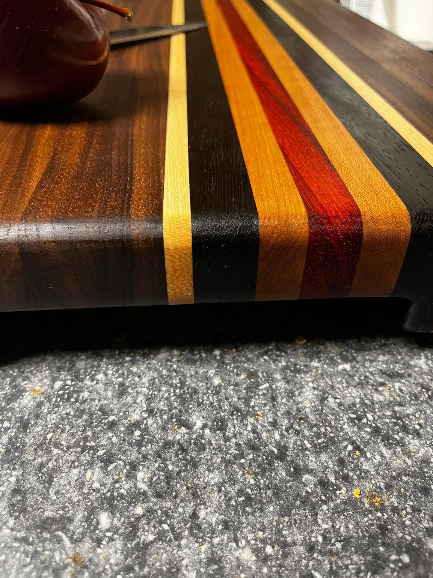 19"L X 13"W X 2"H Walnut edge grain cutting board with cherry, maple, African wenge & padauk accent strips.