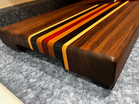 19"L X 13"W X 2"H Walnut edge grain cutting board with cherry, maple, African wenge & padauk accent strips.