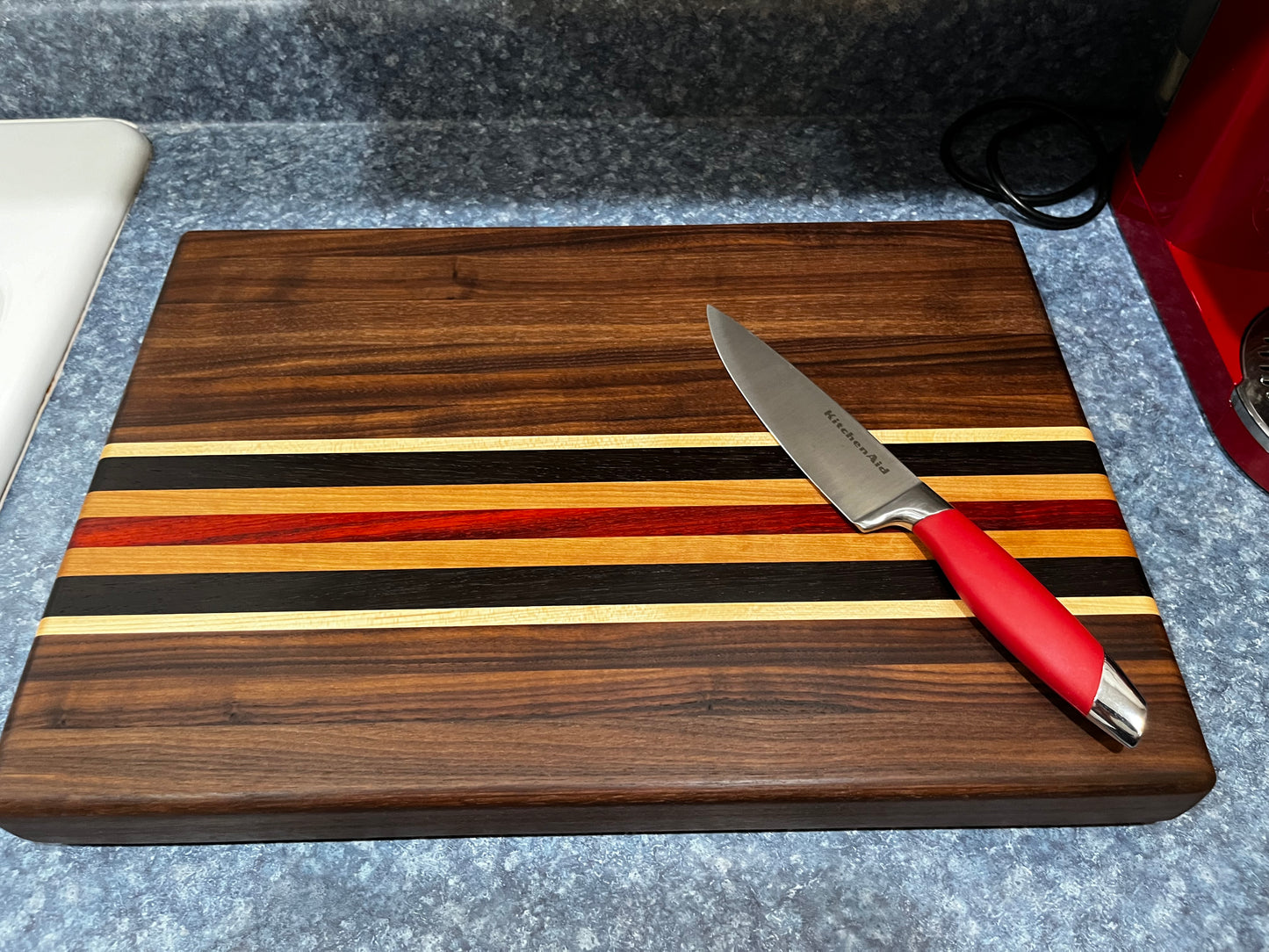 19"L X 13"W X 2"H Walnut edge grain cutting board with cherry, maple, African wenge & padauk accent strips.