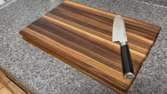 17-1/2"X11-1/2"X1-1/2" Walnut Edge Grain Cutting Board w/Unique Hand Hold around the sides.